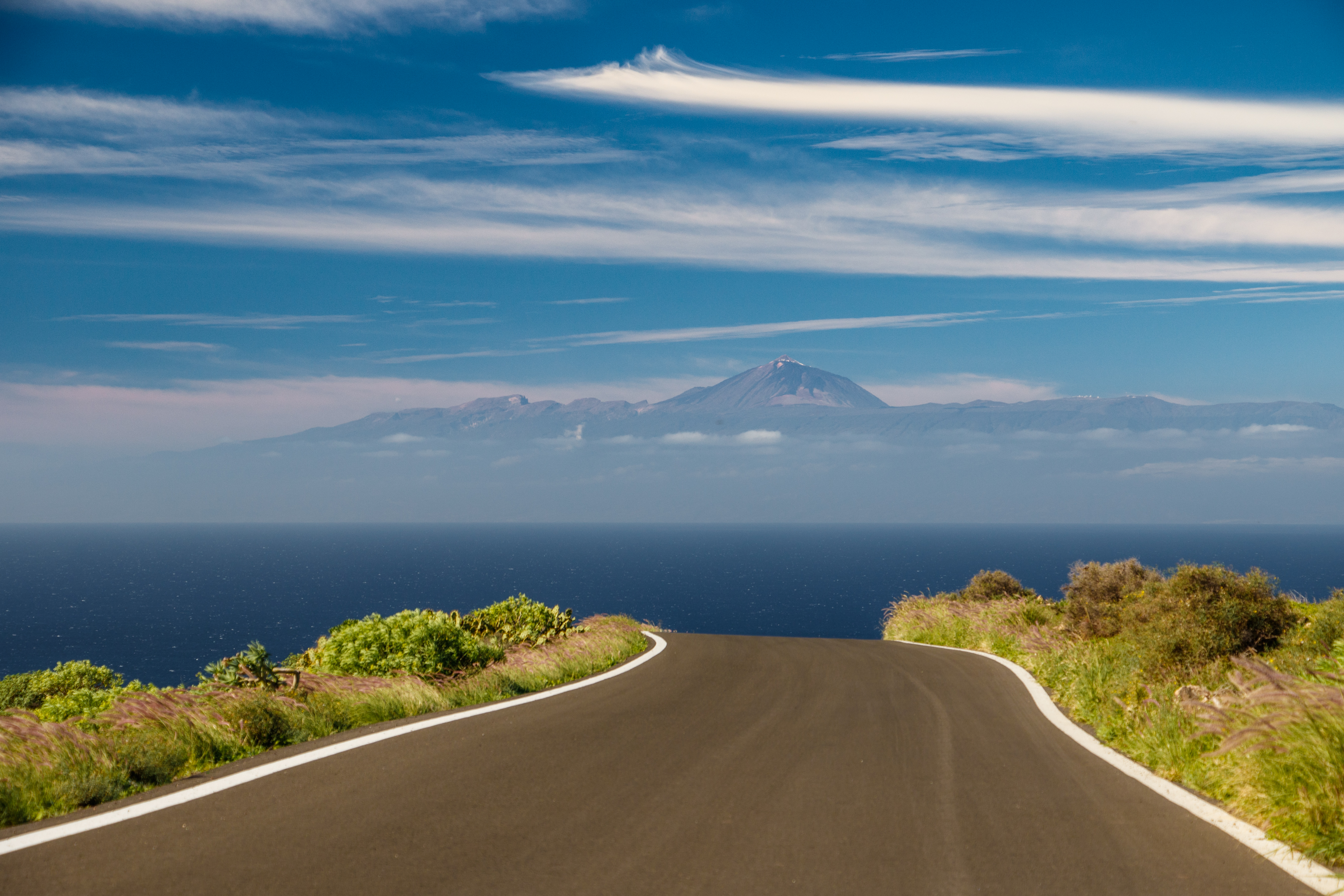 Teide on Tenerife sticking out in the sky above a rural road